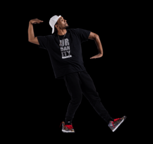 Dancer wearing black in a black background poses in geometrical hip hop shape