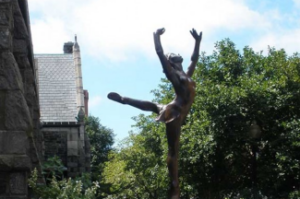 Photo of ballerina in back attitude sculpture in front of José Mateo's headquarters