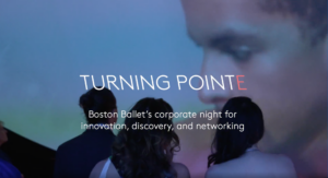 Photo of three people looking back at a projected close-up image of a dancer.