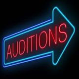 "Auditions" neon sign with an arrow around the word.