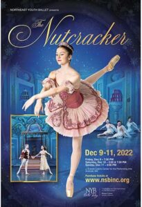 Ballerina in a pink tutu lifts her back leg in an attitute and arms are crossed long in front of her torso.