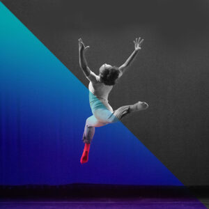 Dancer jumps with both legs bend and staggered while reaching arms up and bending back to look up.