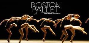 Boston Ballet dancers in black leotards and pointe shoes curve their spines and lift one leg in front in an attitude.