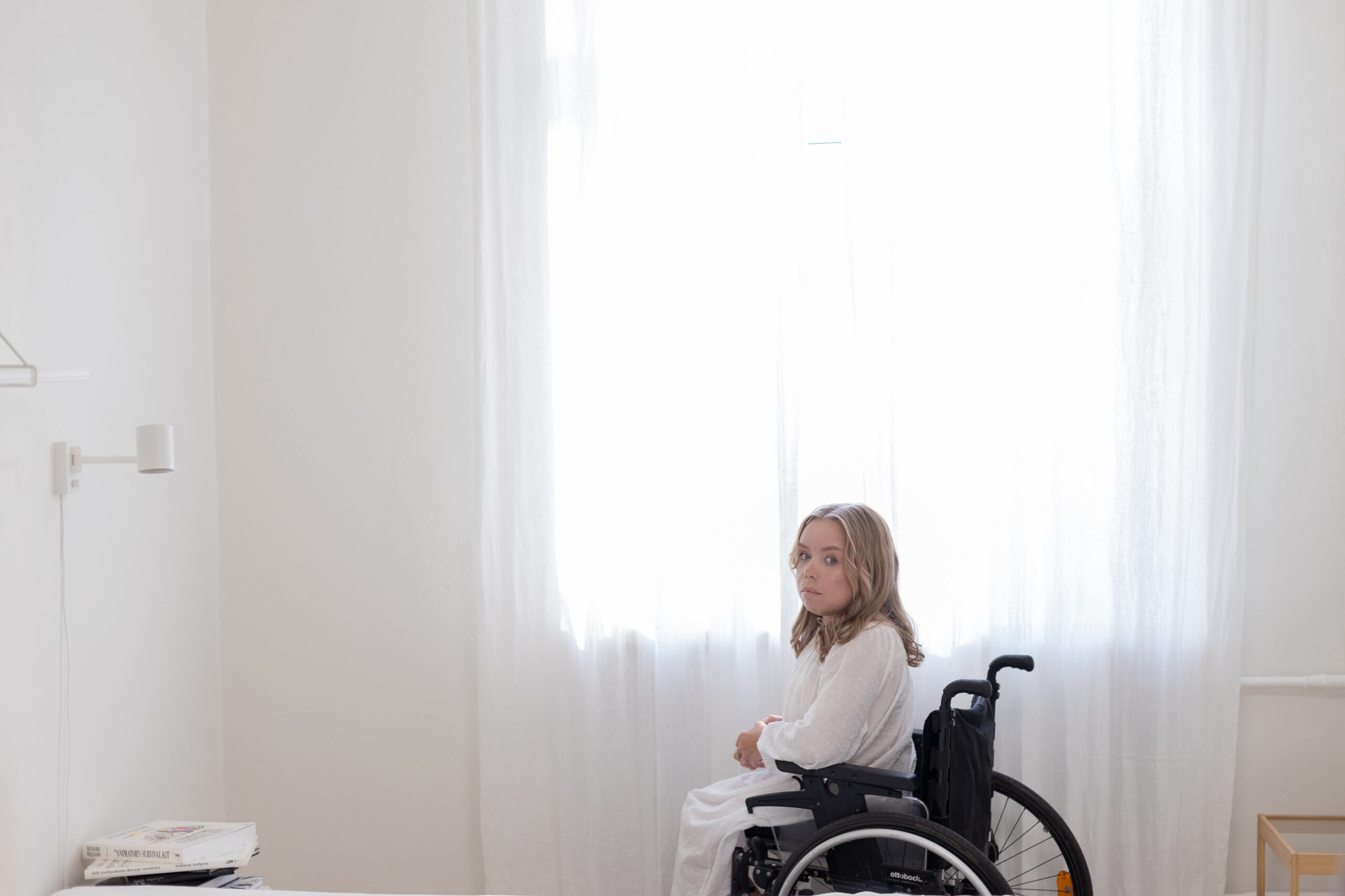 Photo of person in wheelchair in a bright room
