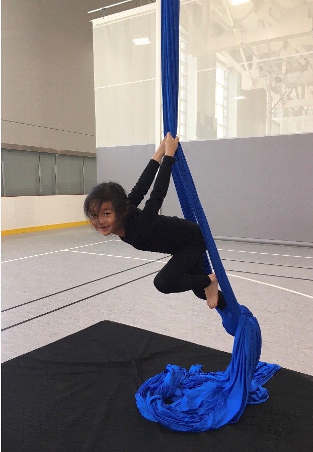 Child hands on aerial silk