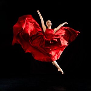 Dancer in red dress leaps