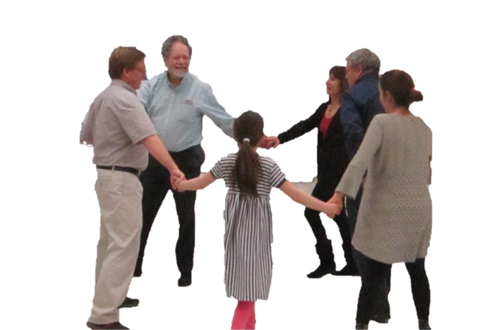 Circle of people holding hands and dancing.