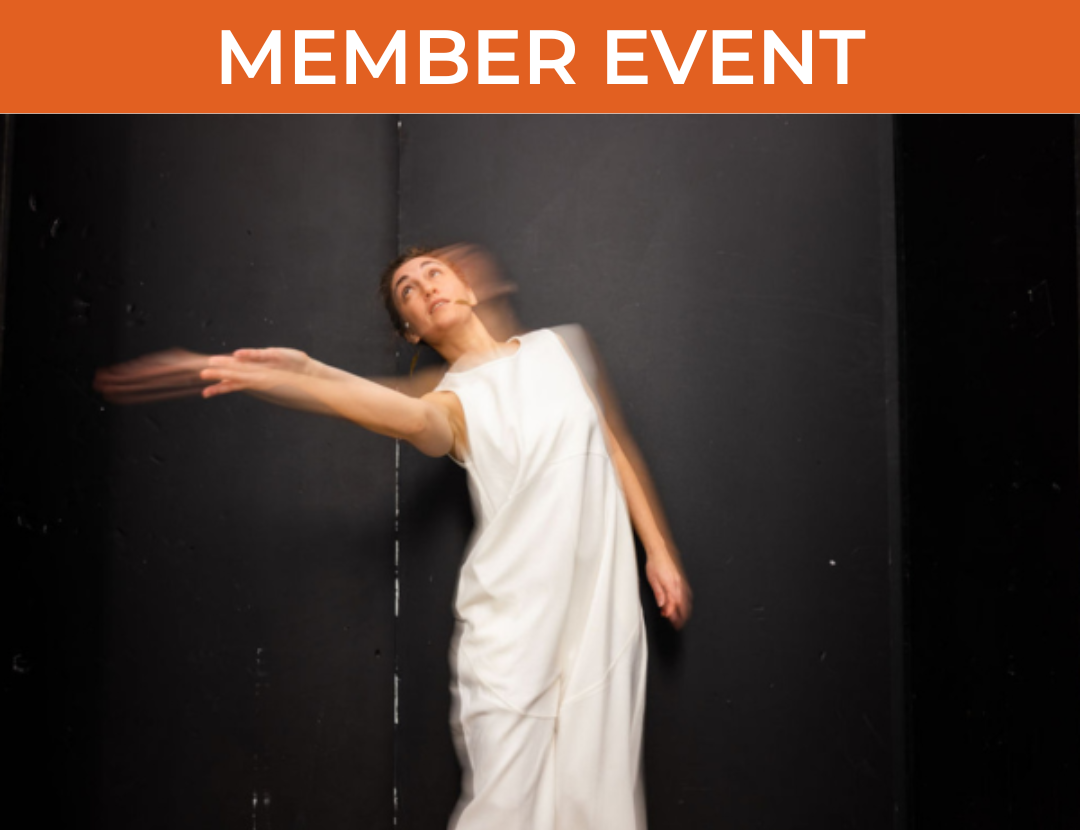 Woman in white gown moved in front of black backdrop, blurred by camera exposure