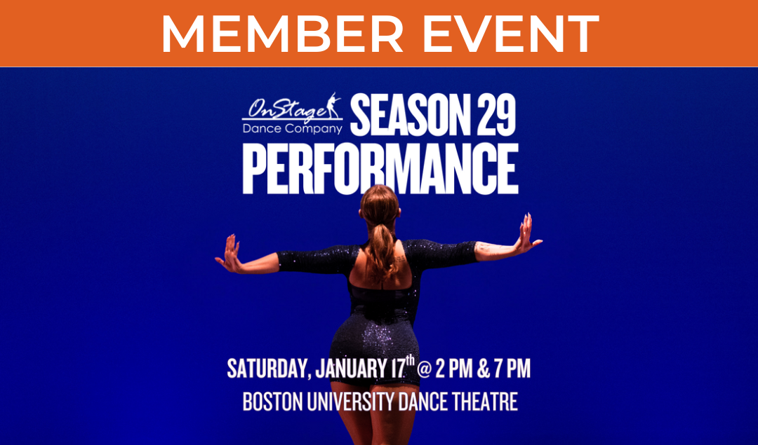 Image of a dance facing away from the camera with their arms stretched to the sides. Dancer is seen from the waist up wearing tight black clothing against a vibrant blue backdrop.