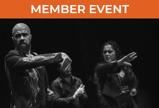 Triana Maciel and Nino de los Reyes, flamenco artists, portrait. Three people are in frame from the waist up in this black and white photo. The two people in focus in the front each have one arm outstretched in movement